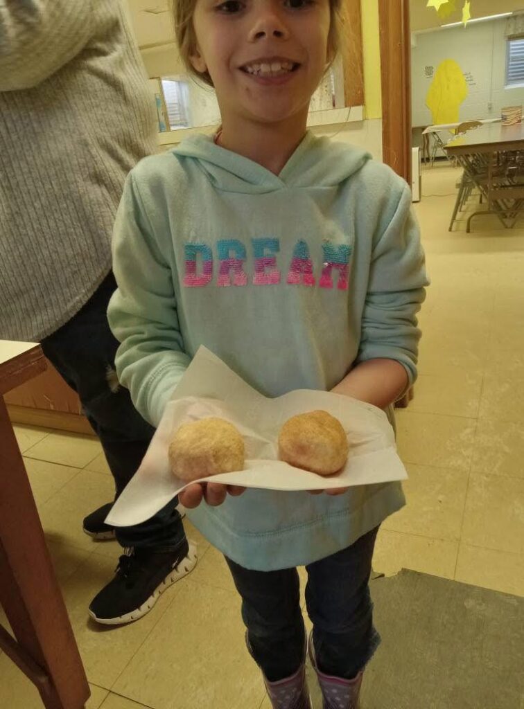 Tomb biscuits 2 Girl holding two biscuits