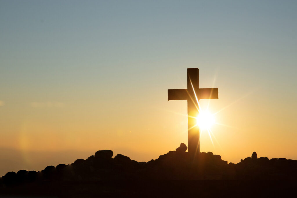 Resurrection concept:Crucifixion Of Jesus Christ Cross At Sunset Cross in front of a sunrise