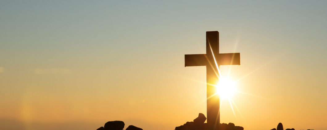 Cross in front of a sunrise